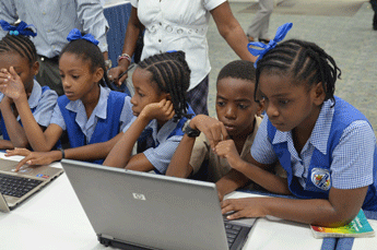 Barbadian children use computers at school.  (Photo Credit: Bardados Advocate)