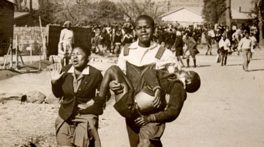 Iconic photo of Hector Pieterson, 13, being carried by Mbuyisa Makhubo after being shot by South African police. His sister, Antoinette Sithole, runs beside them. (Photo taken by Sam Nzima)