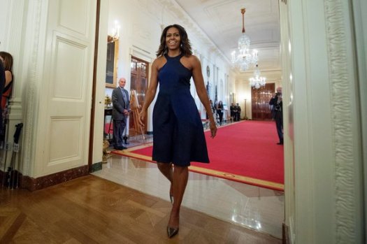 First lady Michelle Obama wears an Oscar de la Renta cocktail dress at the Fashion Education Workshop she hosted at the White House. (Google Images)